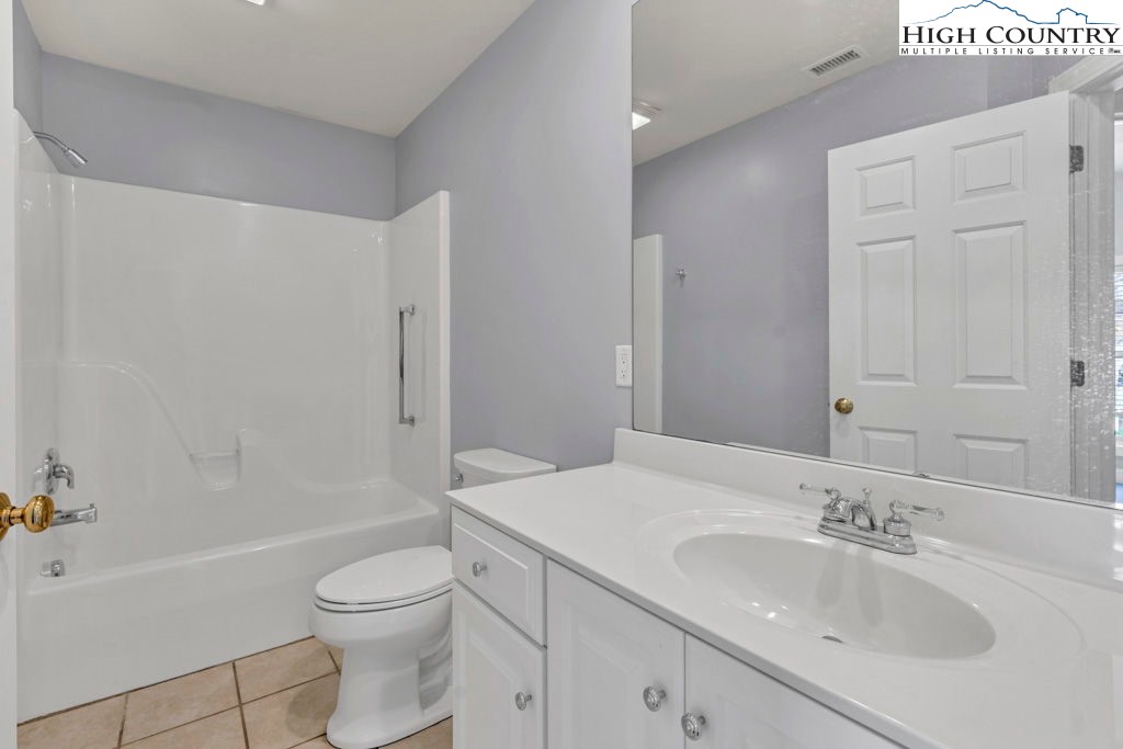 140 Silo Ridge Lane, Unit 140 Vilas, NC 28692 - Photo 21 of 27 a bathroom with a sink a toilet and shower