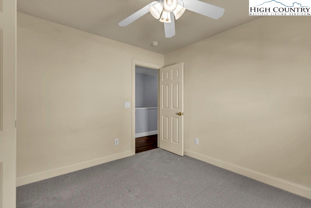 140 Silo Ridge Lane, Unit 140 Vilas, NC 28692 - Photo 23 of 27 an empty room with a chandelier fan