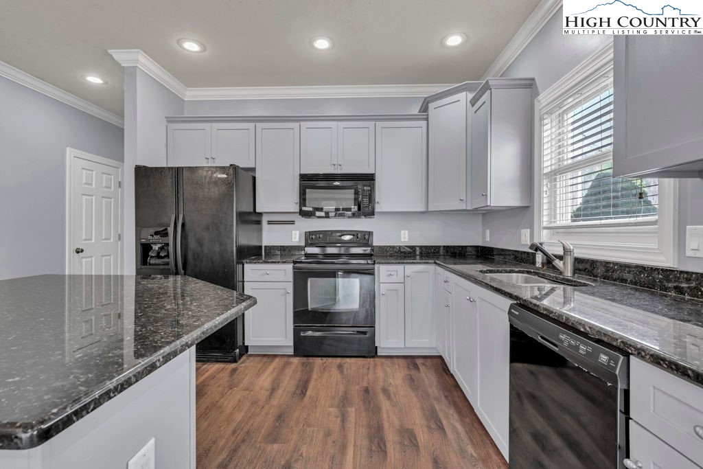 140 Silo Ridge Lane, Unit 140 Vilas, NC 28692 - Photo 3 of 27 a kitchen with stainless steel appliances granite countertop a stove a sink and a refrigerator