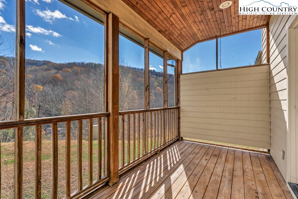 140 Silo Ridge Lane, Unit 140 Vilas, NC 28692 - Photo 5 of 27 a view of a balcony with wooden floor and fence