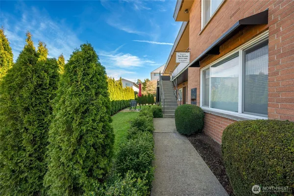 a view of a house with potted plants
