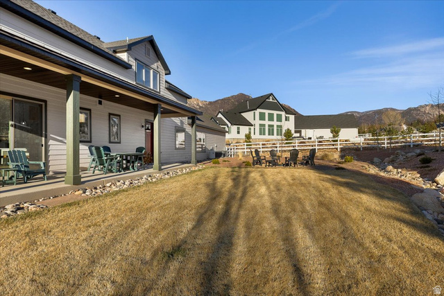 1210 East Bristle Cone Road Pine Valley, UT 84781 - Photo 47 of 54 View of yard with a mountain view, outdoor dining space, and covered porch