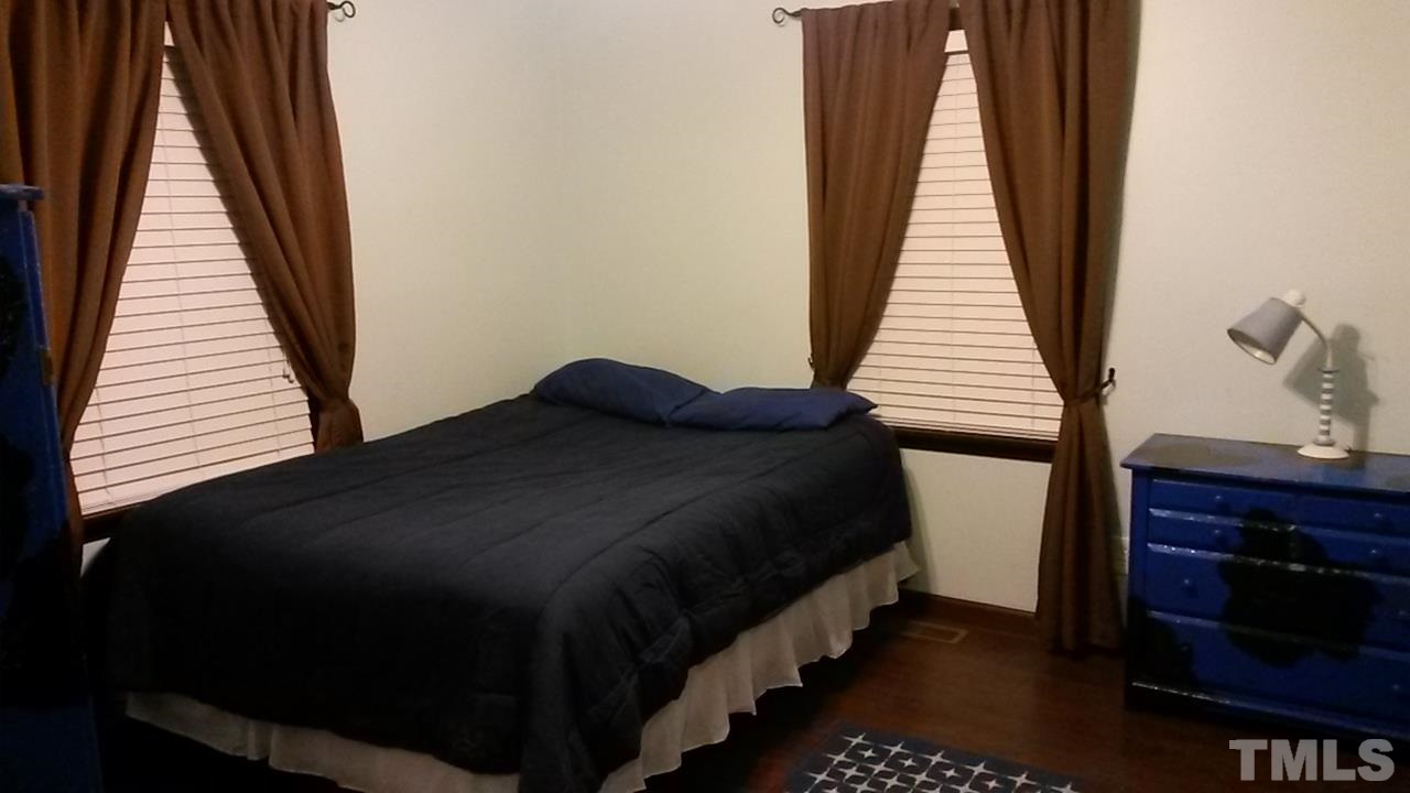 1144 Brighton Road Raleigh, NC 27610 - Photo 13 of 24 a bedroom with a bed and wooden floor