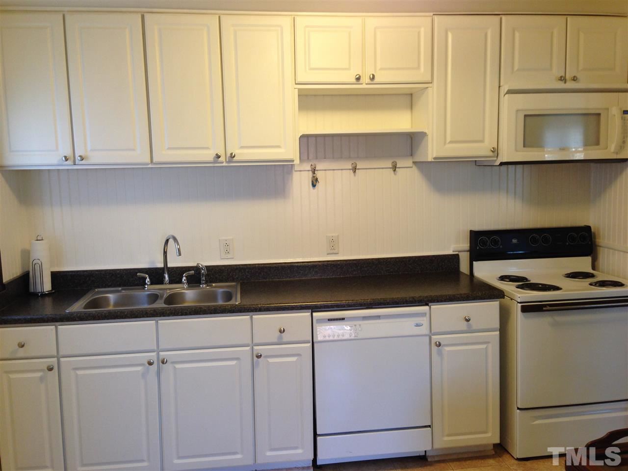 1144 Brighton Road Raleigh, NC 27610 - Photo 4 of 24 a kitchen with granite countertop white cabinets and a stove