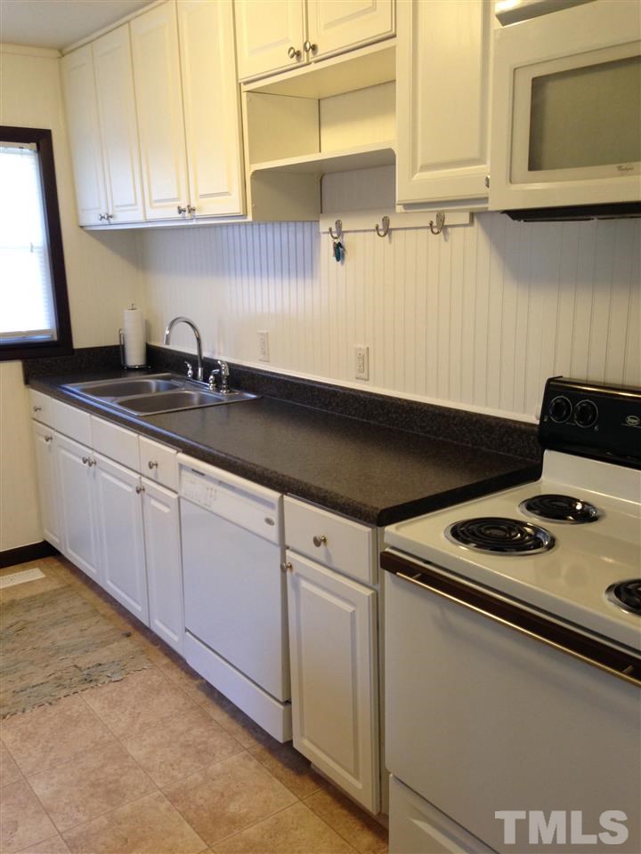 1144 Brighton Road Raleigh, NC 27610 - Photo 5 of 24 a kitchen with granite countertop a sink stove and cabinets