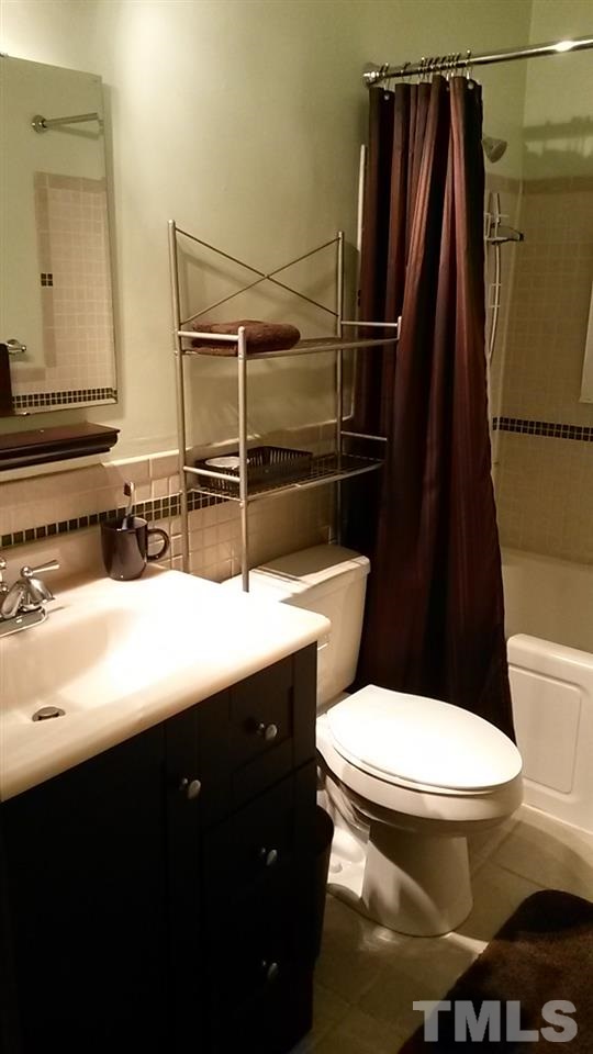 1144 Brighton Road Raleigh, NC 27610 - Photo 10 of 24 a bathroom with a sink toilet and shower