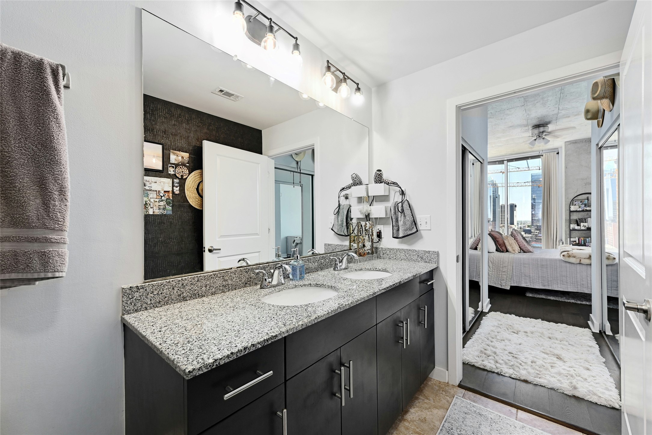 360 Nueces Street, Unit 1809 Austin, TX 78701 - Photo 17 of 25 Bathroom with a dual vanity featuring a speckled countertop and undermount sinks