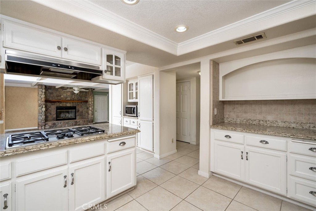 34150 Stowe Road Winchester, CA 92545 - Photo 11 of 80 a kitchen with white cabinets and appliances
