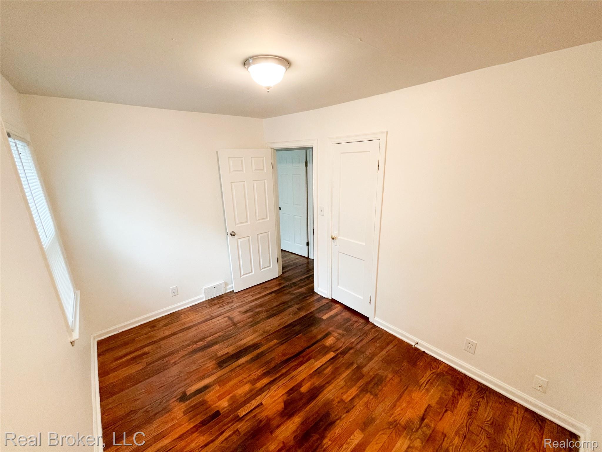 603 Vernier Road Grosse Pointe, MI 48236 - Photo 8 of 33 Unfurnished bedroom with dark wood finished floors and baseboards
