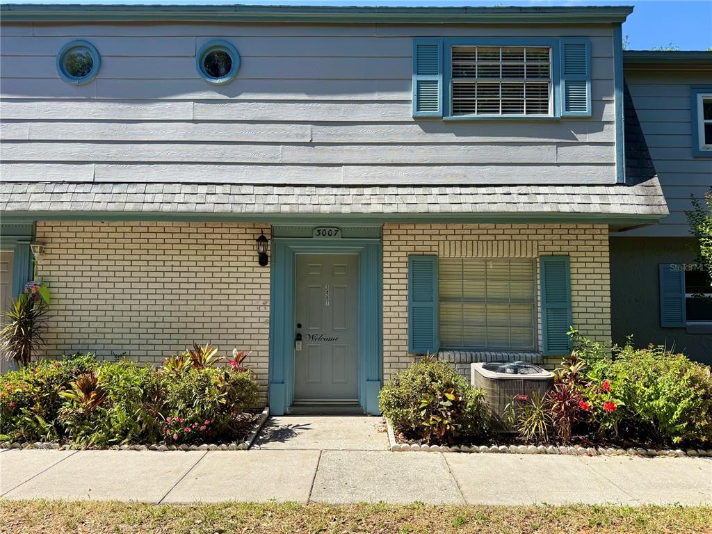 a view of a house with potted plants
