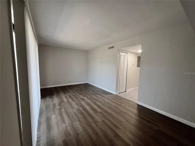 an empty room with wooden floor