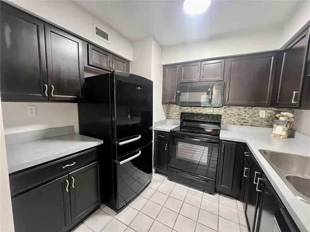 a kitchen with a refrigerator and a sink