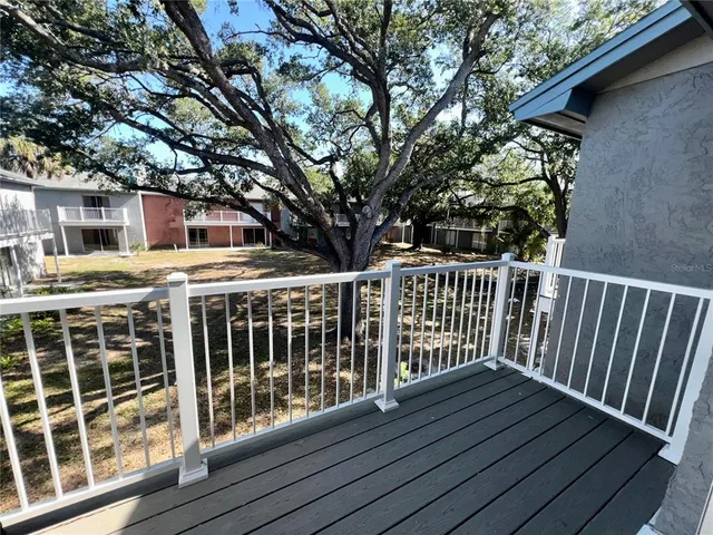 a view of a wooden deck and a yard