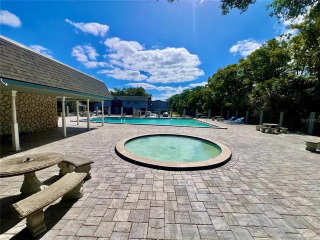 a view of a swimming pool with a patio