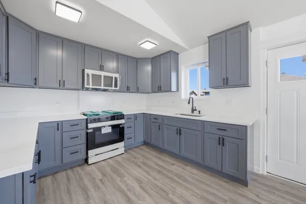 a kitchen with stainless steel appliances granite countertop a stove and a sink