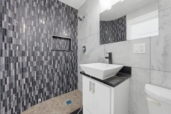 a bathroom with a sink toilet and shower