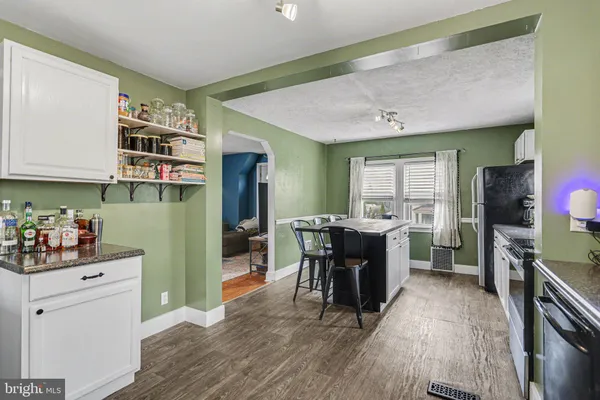 a kitchen with a refrigerator and a dining table
