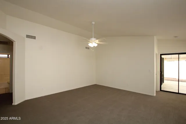 an empty room with a empty space and a ceiling fan