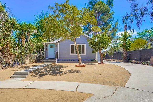 a backyard of a house with yard and outdoor seating