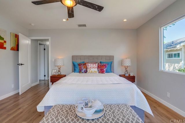 a bedroom with a bed and wooden floor