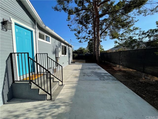 an outdoor sitting area with furniture on wooden floor