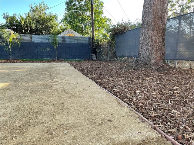 a outdoor sitting area with wooden benches in front of it