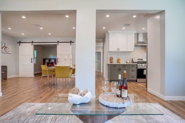 a living room with furniture and kitchen view