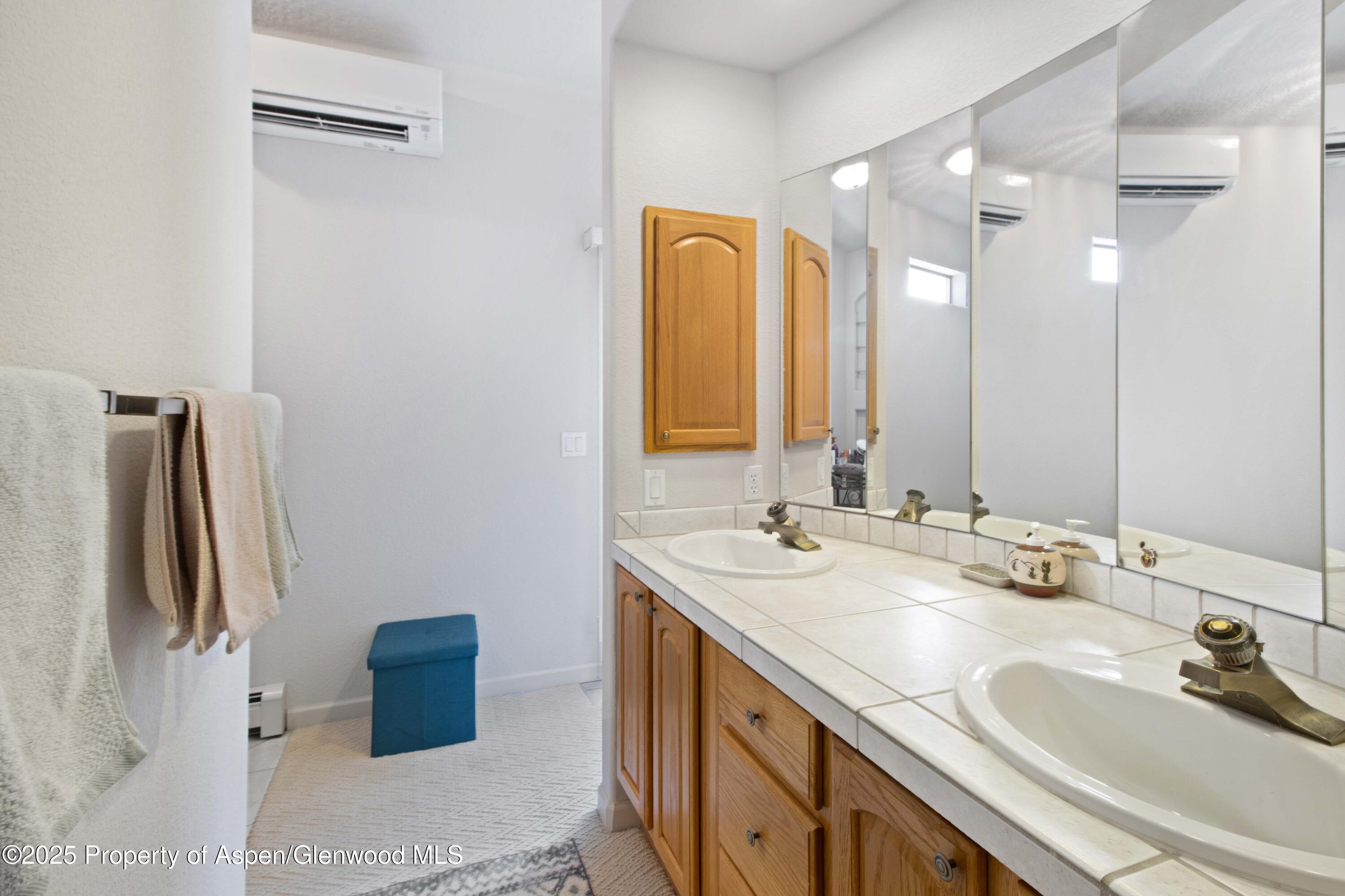 74 Hogan Circle Parachute, CO 81635 - Photo 14 of 26 a bathroom with a double vanity sink and mirror
