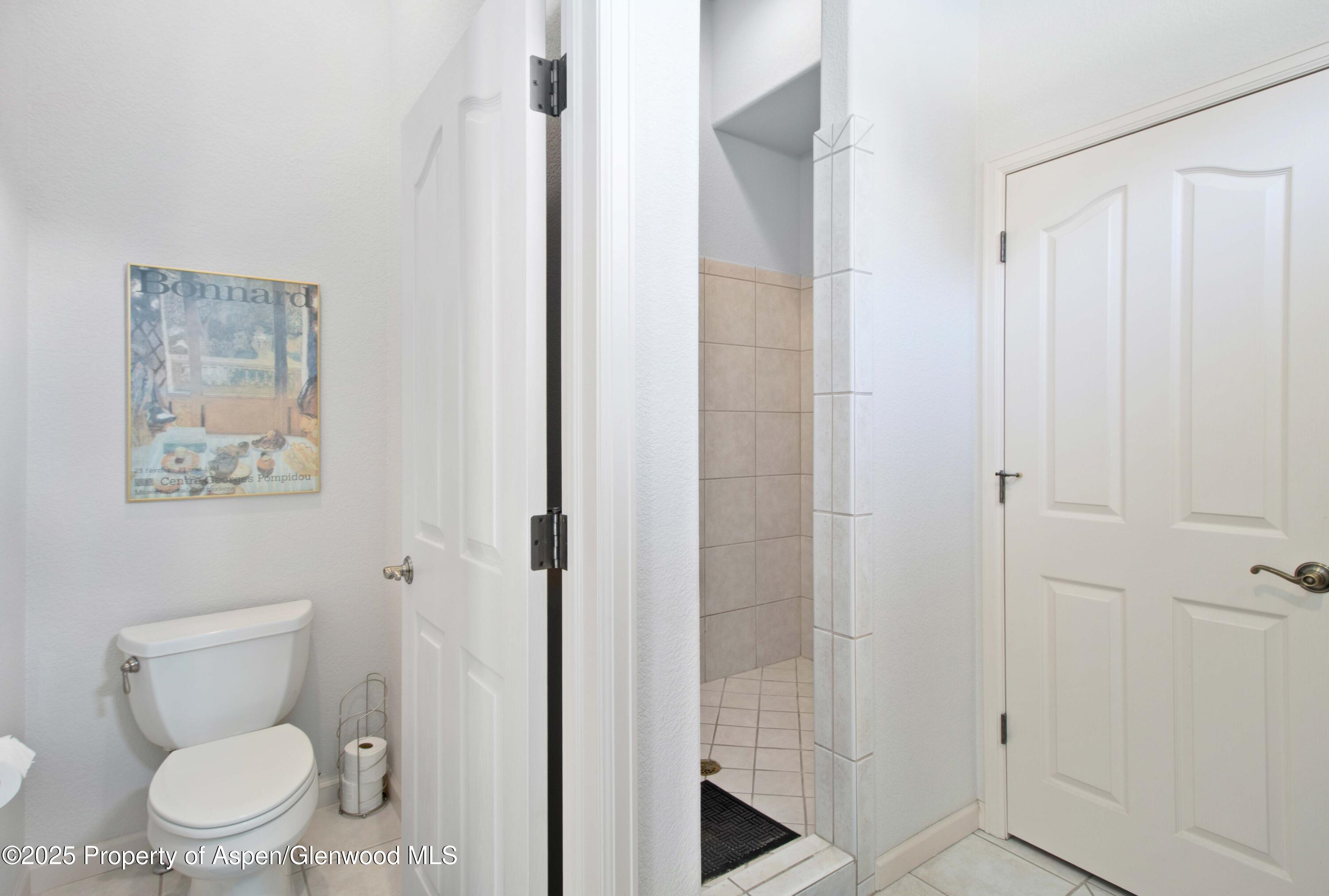 74 Hogan Circle Parachute, CO 81635 - Photo 15 of 26 a white toilet sitting next to a bathroom sink