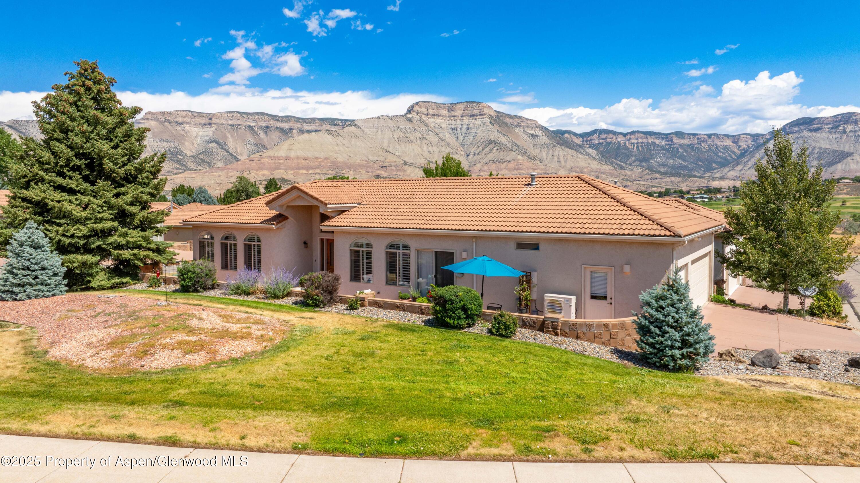 74 Hogan Circle Parachute, CO 81635 - Photo 21 of 26 a front view of house with yard outdoor seating and barbeque