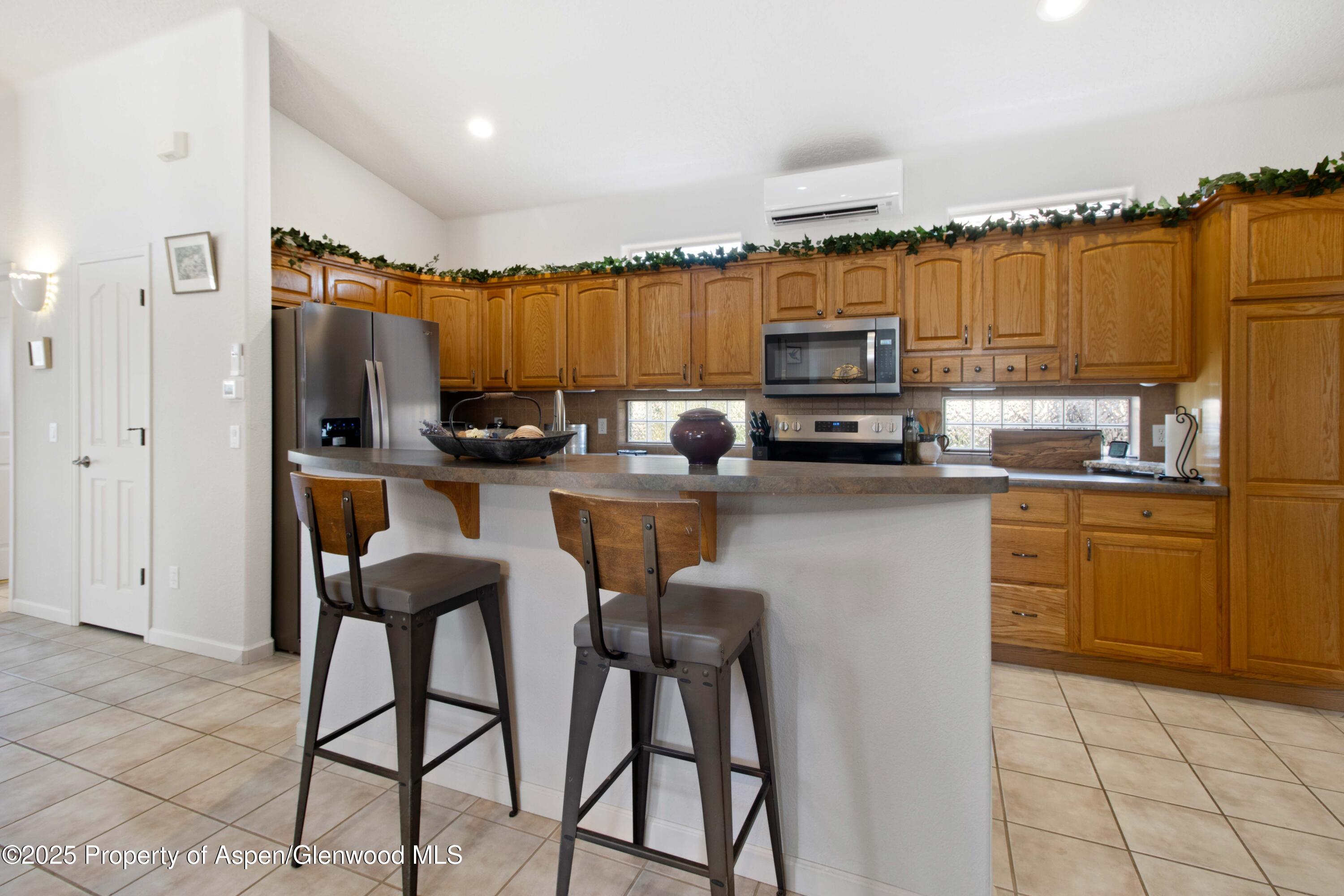 74 Hogan Circle Parachute, CO 81635 - Photo 6 of 26 a kitchen with stainless steel appliances a stove a sink and a refrigerator