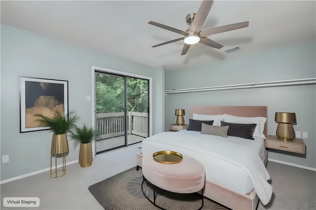 a bedroom with a large bed and a potted plant