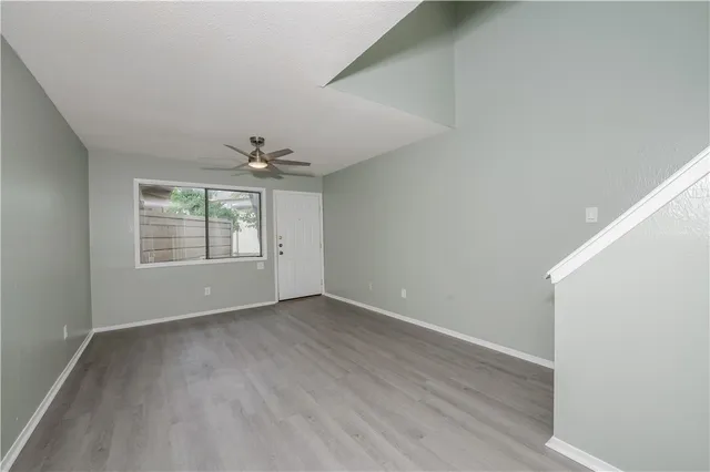 wooden floor in an empty room with a window