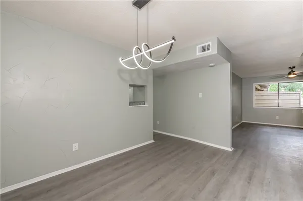 a view of a room with wooden floor and white walls