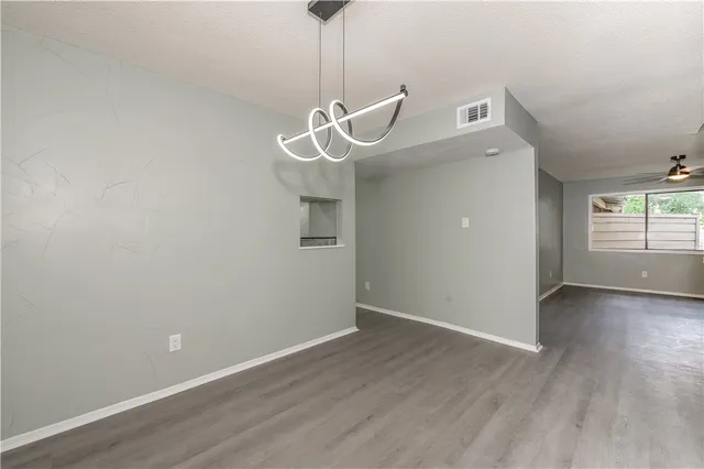 a view of a room with wooden floor and white walls