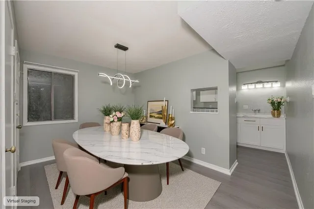 a view of a dining room with furniture and wooden floor
