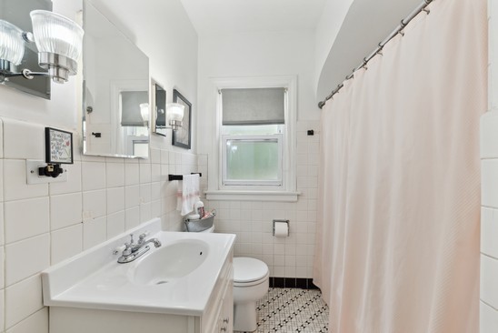 1220 South Fairview Avenue Park Ridge, IL 60068 - Photo 11 of 19 a bathroom with a sink a toilet and shower curtain