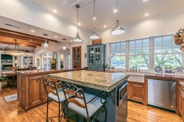a large kitchen with a table and chairs
