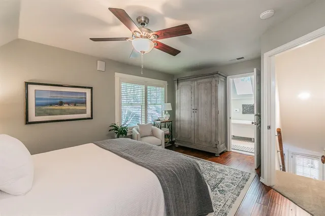 a bedroom with a large bed and a chandelier