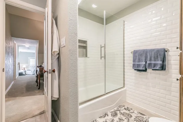 a bathroom with a tub and shower
