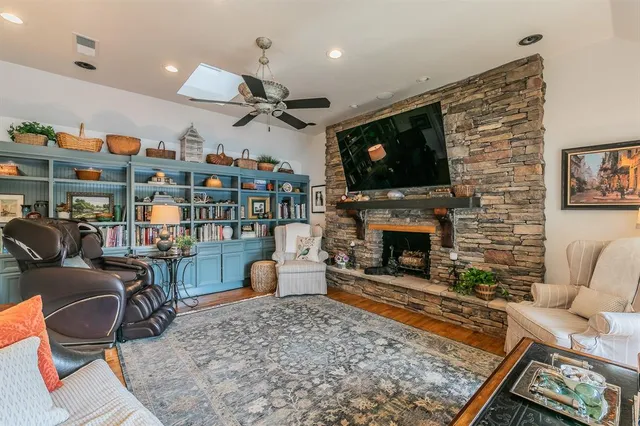 a living room with furniture a flat screen tv and a fireplace