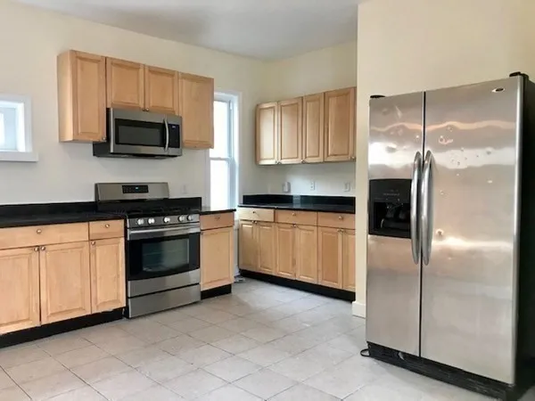 a kitchen with a refrigerator stove and microwave