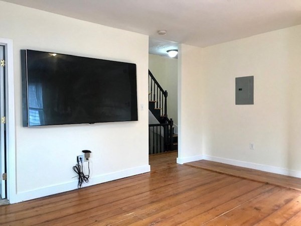22 Marcella Street, Unit 2 Boston, MA 02119 - Photo 7 of 12 a living room with a flat screen tv and wooden floor
