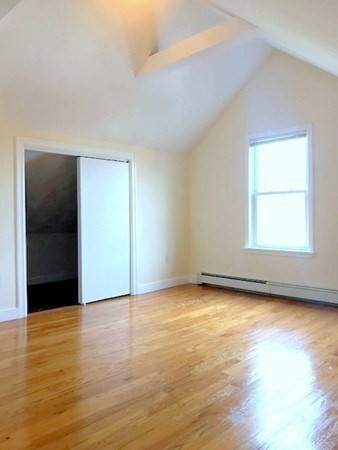 22 Marcella Street, Unit 2 Boston, MA 02119 - Photo 10 of 12 an empty room with wooden floor and windows