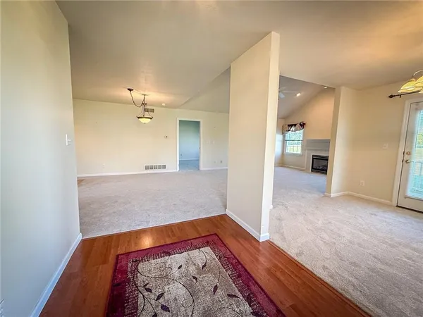 wooden floor in a room with a kitchen