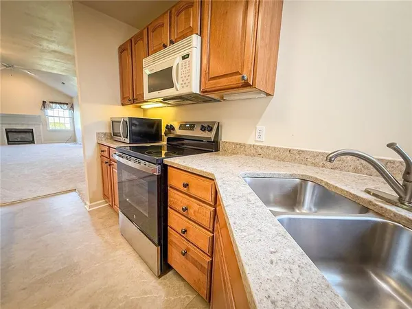 a kitchen with stainless steel appliances granite countertop a sink and a stove