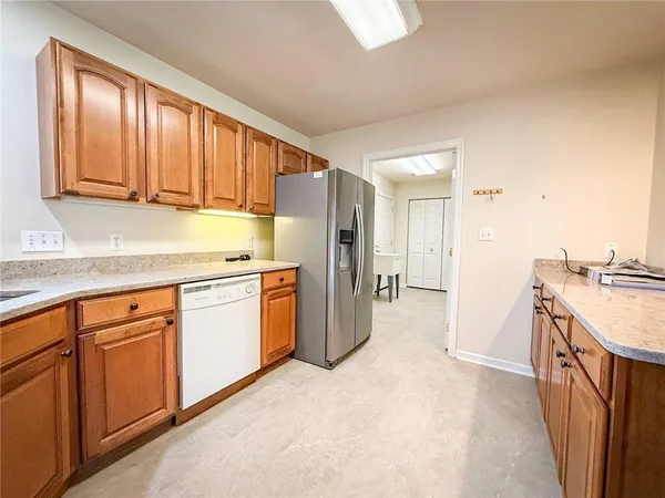 a kitchen with a sink stove and refrigerator