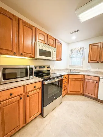 a kitchen with stainless steel appliances granite countertop a sink and cabinets