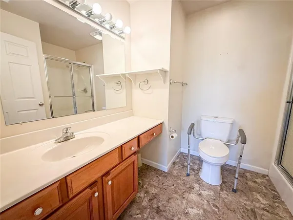 a bathroom with a sink toilet and shower