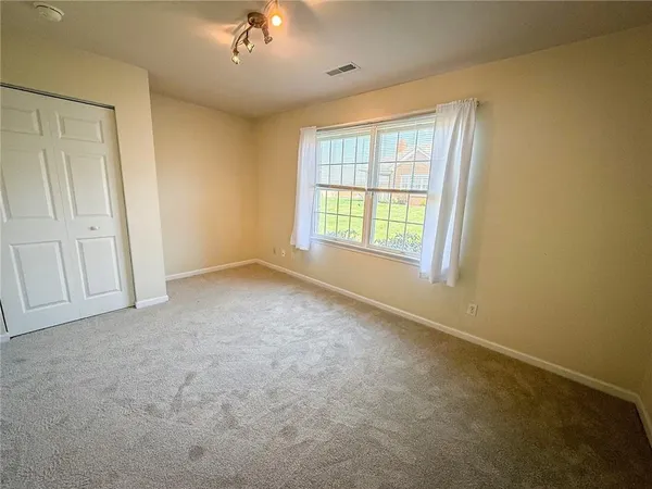 an empty room with a empty space and windows